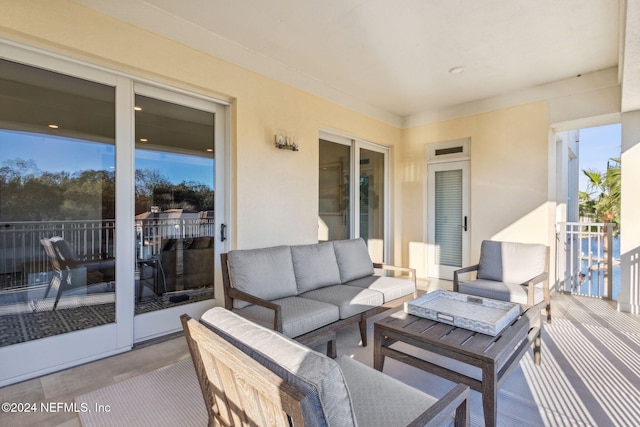 view of patio with outdoor lounge area and a balcony