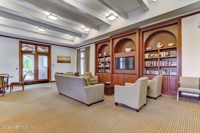 carpeted living room with french doors and beamed ceiling