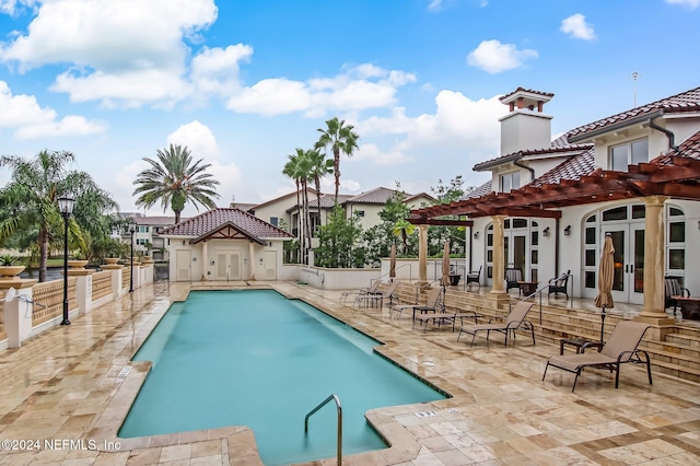 view of pool featuring a patio area and french doors