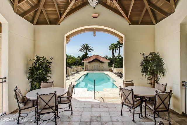 view of swimming pool featuring a patio area and an outbuilding