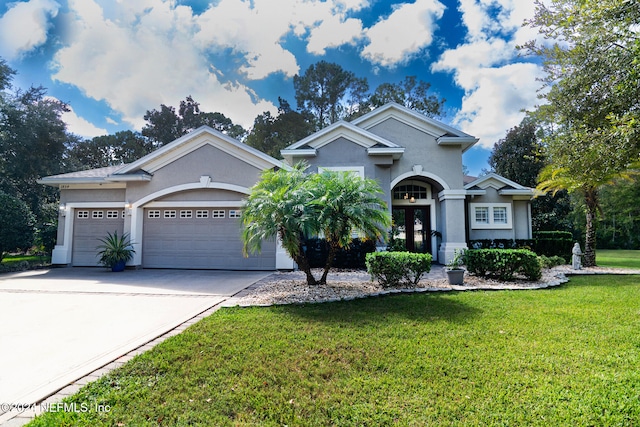 view of front facade with french doors, a front lawn, and a garage