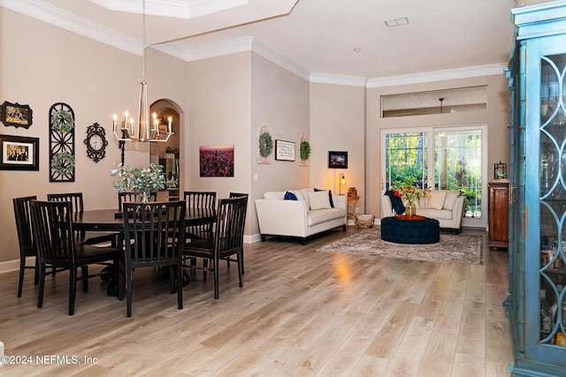 1854 W Cobblestone Ln, Saint Augustine, FL 32092 - dining space with a chandelier, light wood-style floors, crown molding, and baseboards