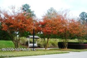 1854 W Cobblestone Ln, Saint Augustine, FL 32092 - surrounding community with a lawn