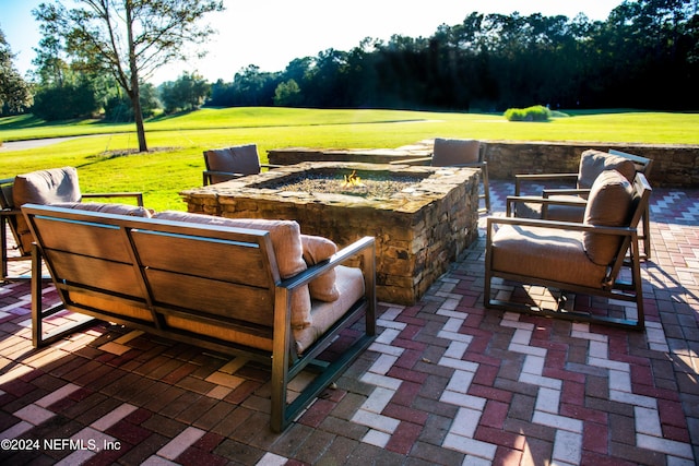 view of patio with an outdoor living space with a fire pit