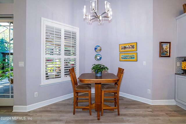 1854 W Cobblestone Ln, Saint Augustine, FL 32092 - dining room featuring a chandelier, light wood-style floors, baseboards, and a high ceiling
