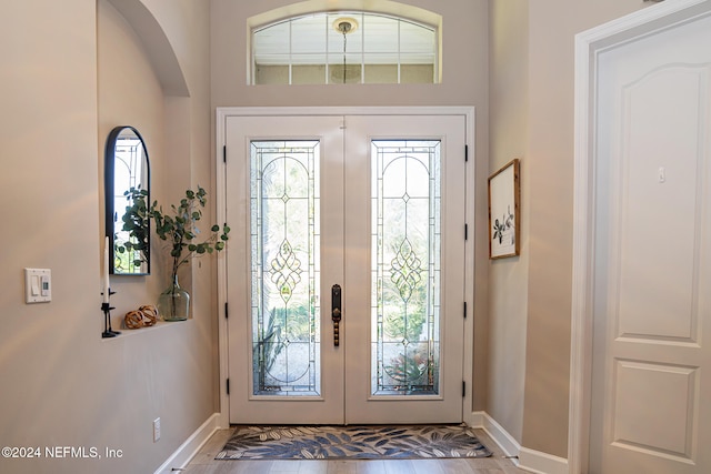 entrance foyer with french doors and hardwood / wood-style floors