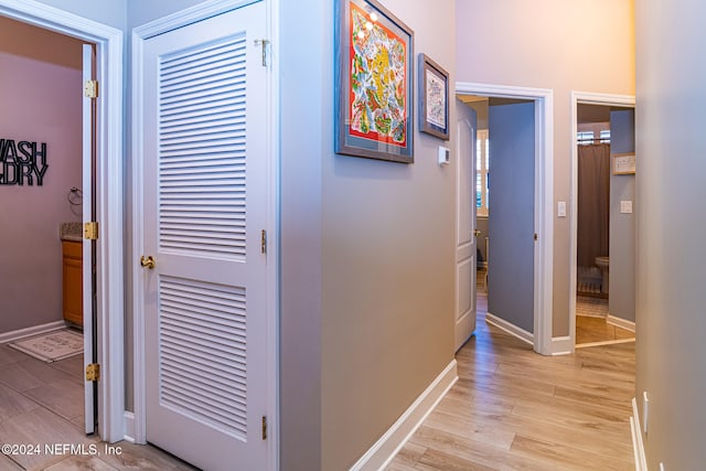 corridor with light hardwood / wood-style flooring