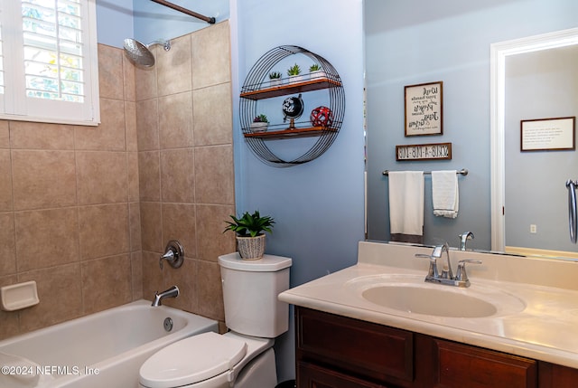 full bathroom with vanity, toilet, and tiled shower / bath