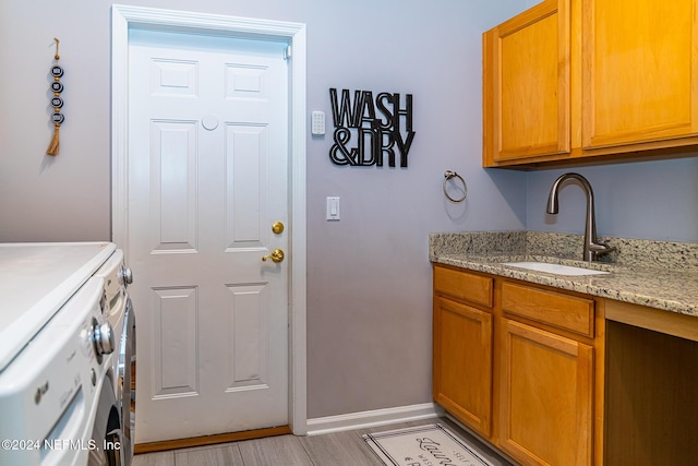 1854 W Cobblestone Ln, Saint Augustine, FL 32092 - washroom featuring cabinet space, washing machine and clothes dryer, baseboards, and light wood-style floors