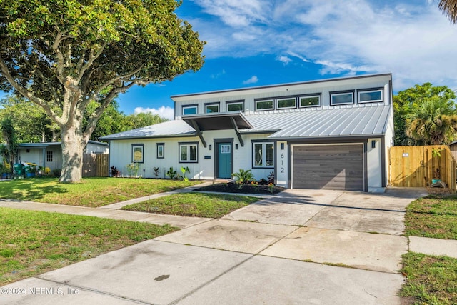 view of property with a garage and a front yard