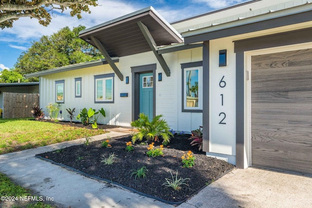 doorway to property with a garage