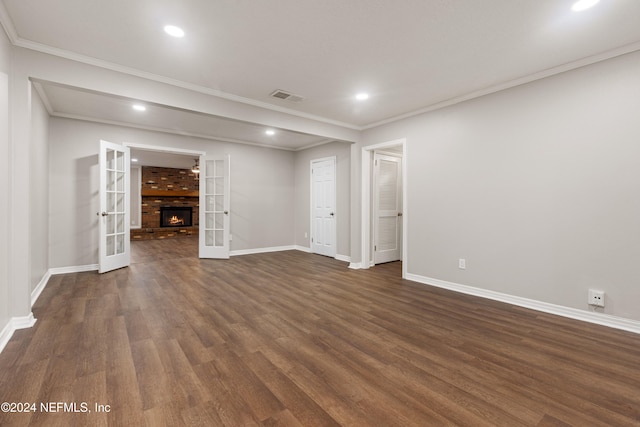 unfurnished living room with french doors, dark hardwood / wood-style flooring, and crown molding