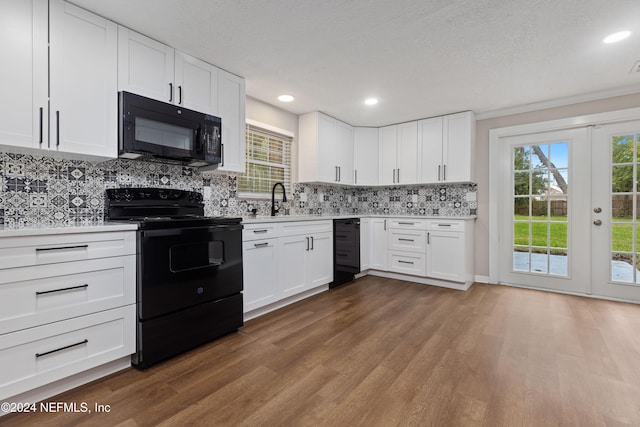 kitchen featuring wood-type flooring, white cabinetry, french doors, and black appliances