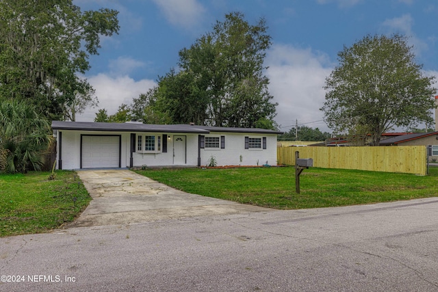 ranch-style house with a garage and a front yard