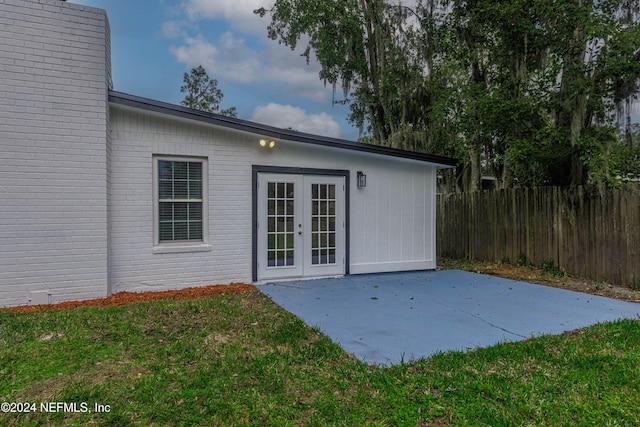 exterior space featuring french doors, a patio, and a yard