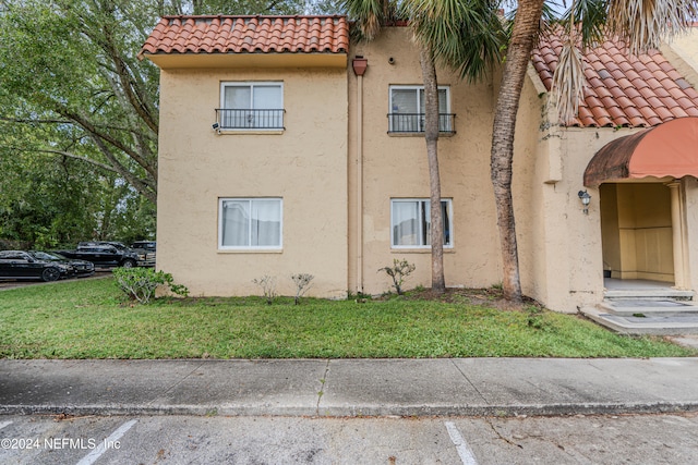 view of side of home with a lawn