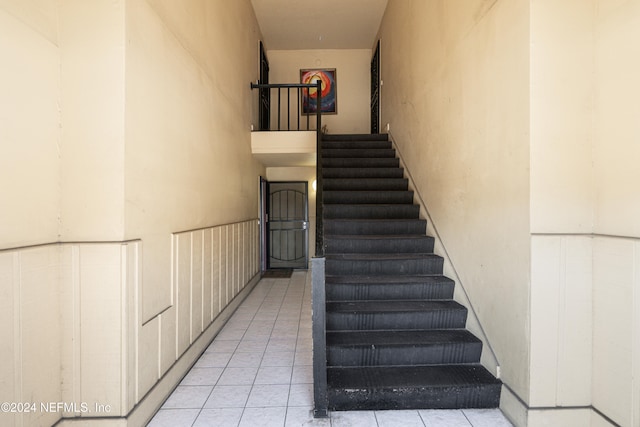 stairs with tile patterned floors