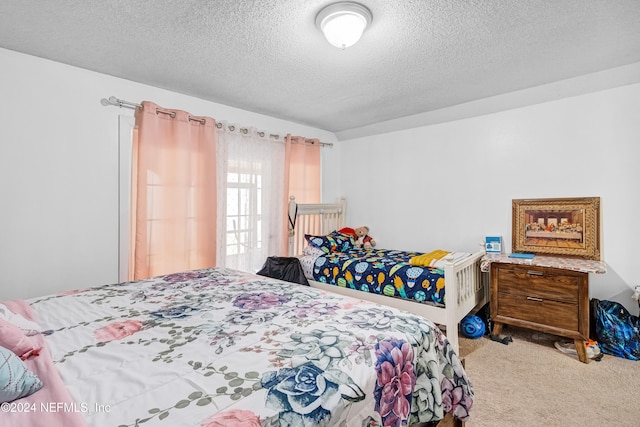 bedroom featuring carpet floors and a textured ceiling