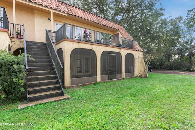 rear view of house with a yard