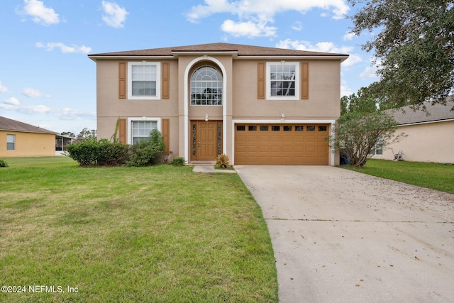 view of front property featuring a front lawn and a garage