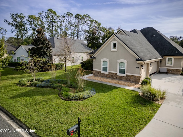 view of front of property with a front yard and a garage