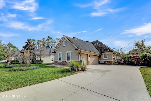 view of front of house with a front yard and a garage