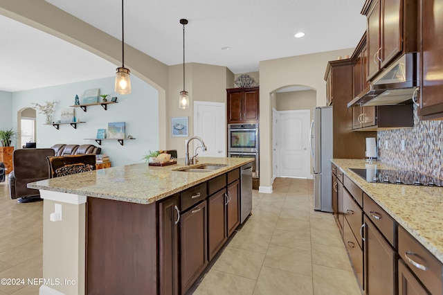 kitchen with a kitchen island with sink, ventilation hood, sink, decorative light fixtures, and stainless steel appliances