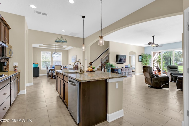 kitchen featuring a wealth of natural light, sink, and pendant lighting