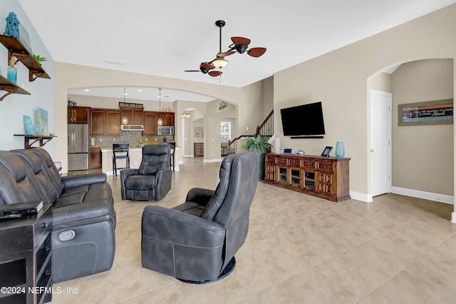 living room with ceiling fan and light tile patterned flooring