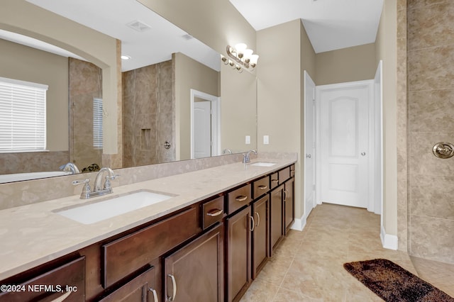 bathroom featuring tile patterned floors, vanity, and tiled shower