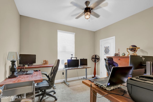 carpeted office space featuring ceiling fan