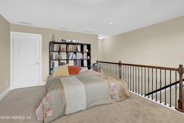 bedroom with carpet and a textured ceiling