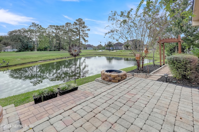 view of patio with a water view and an outdoor fire pit