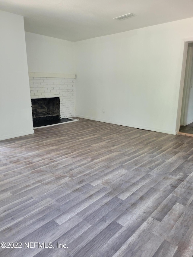 unfurnished living room with light wood-type flooring and a fireplace