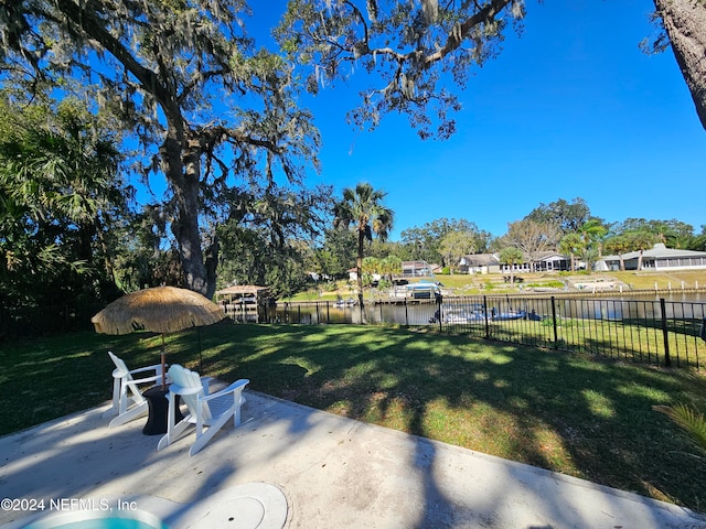 view of yard with a water view and a patio area