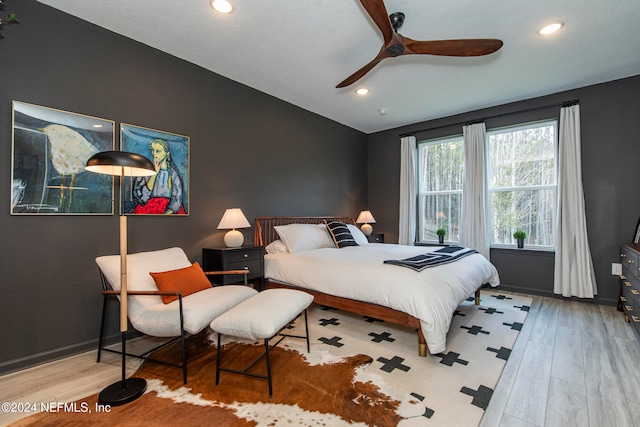 bedroom with ceiling fan and wood-type flooring