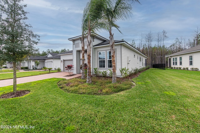 view of front of house featuring a front yard and a garage