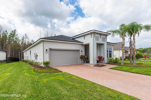 view of front of home with a garage and a front yard