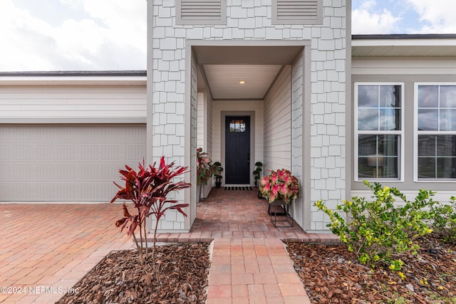 view of exterior entry featuring a garage