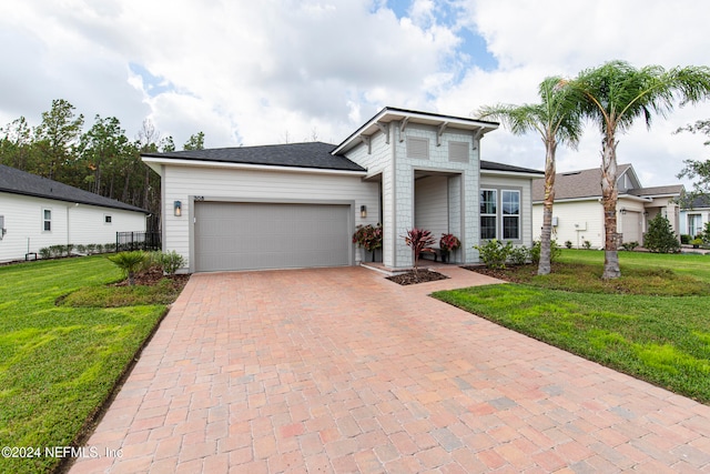 view of front facade featuring a garage and a front lawn