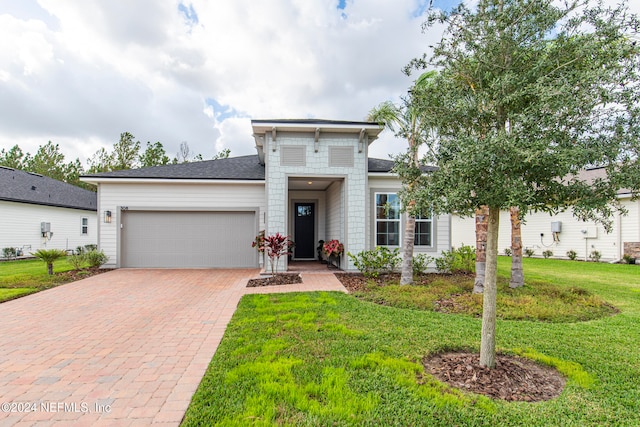 view of front of property with a front lawn and a garage