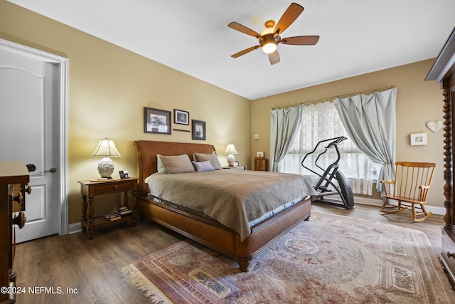 bedroom with dark hardwood / wood-style floors and ceiling fan