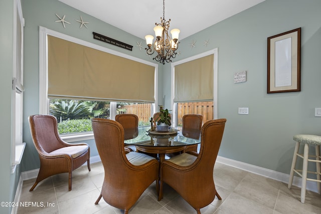 tiled dining space with a notable chandelier