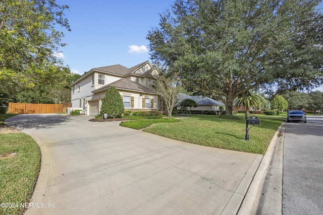 view of front of home featuring a garage and a front lawn