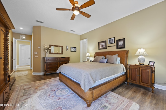 bedroom featuring ceiling fan and dark wood-type flooring