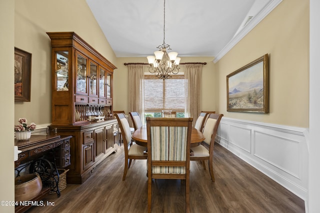 dining space with a chandelier, dark hardwood / wood-style floors, vaulted ceiling, and crown molding