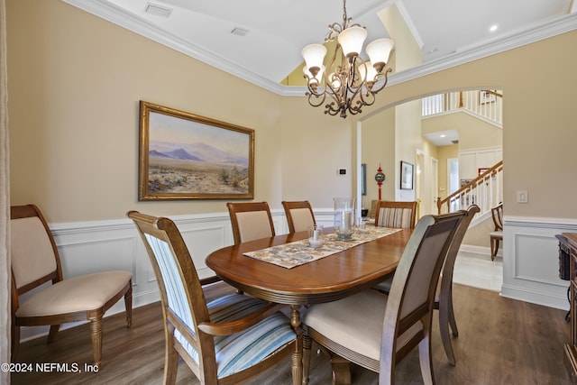 dining room with ornamental molding, dark wood-type flooring, and a notable chandelier