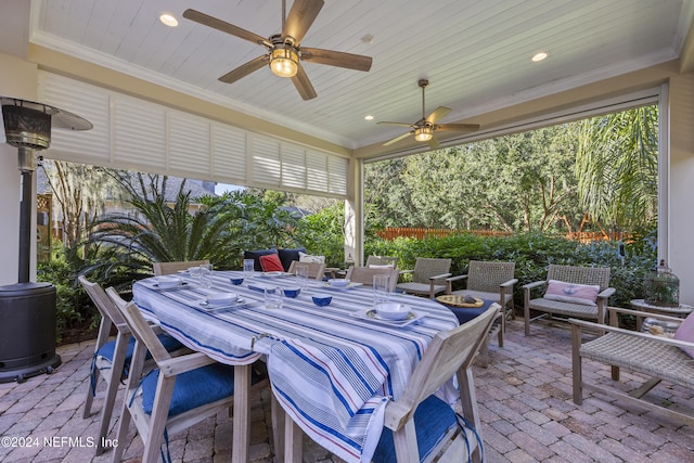 sunroom / solarium featuring ceiling fan and wood ceiling