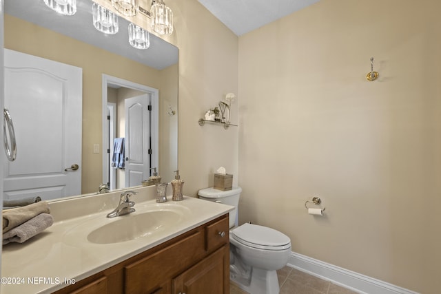 bathroom featuring tile patterned flooring, vanity, and toilet