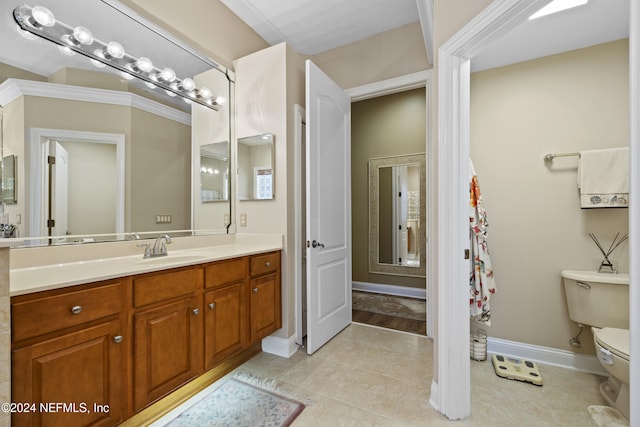 bathroom featuring tile patterned floors, vanity, and toilet